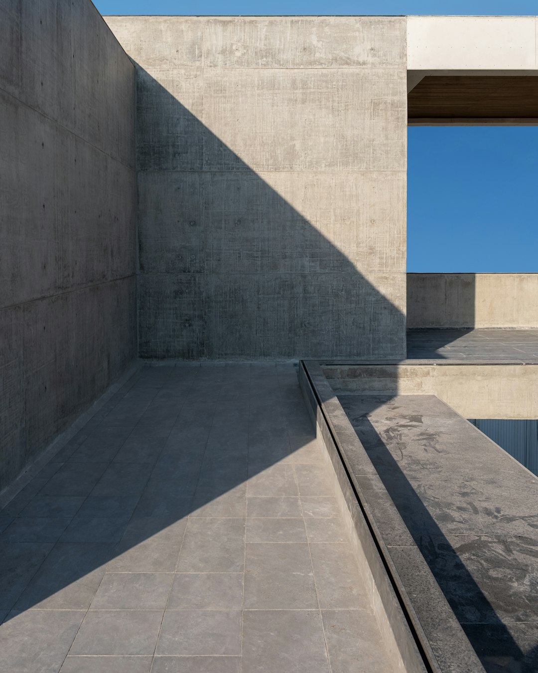 Concrete plaza and ramp beside a commercial building