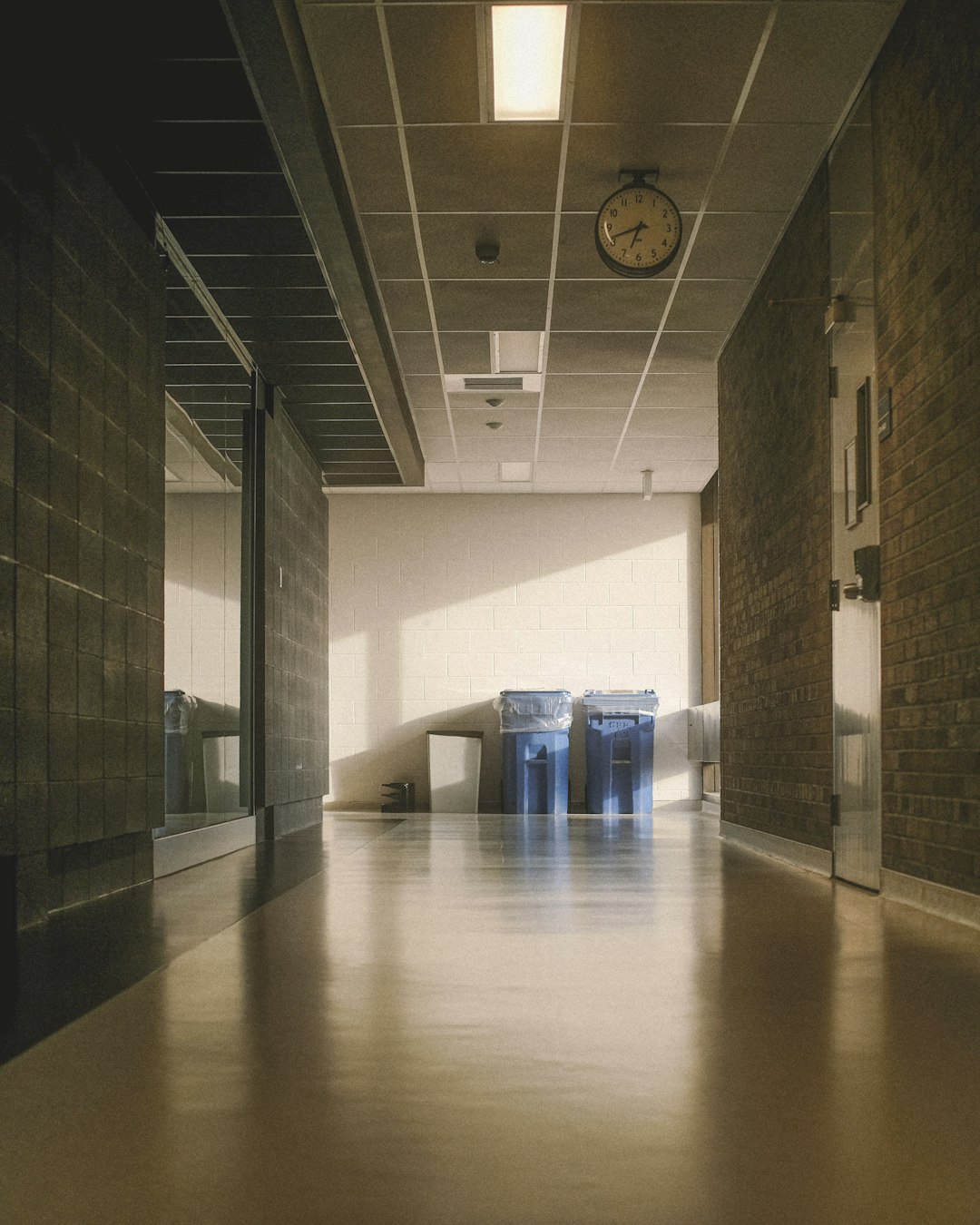 Bright building corridor with a clean, glossy floor